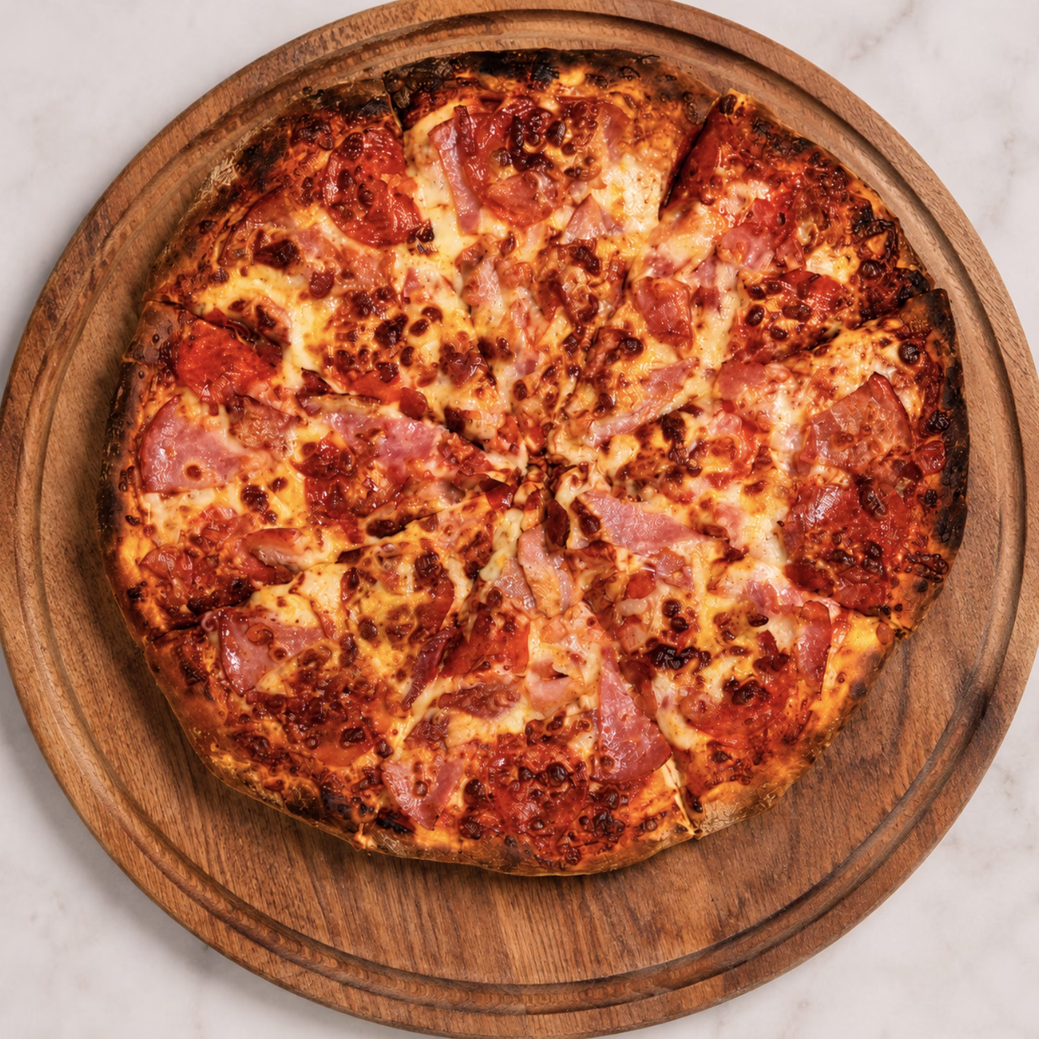 Meat Lovers pizza from Da MUNCH House topped with multiple meats and melted cheese